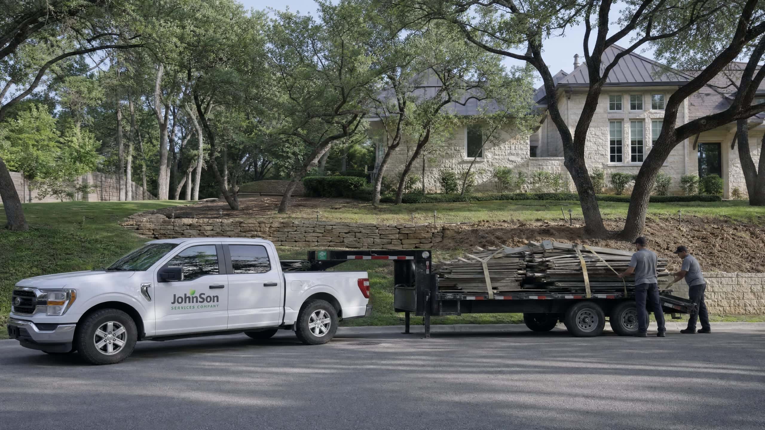 The old fence strapped down on a flatbed at the curb, ready to leave