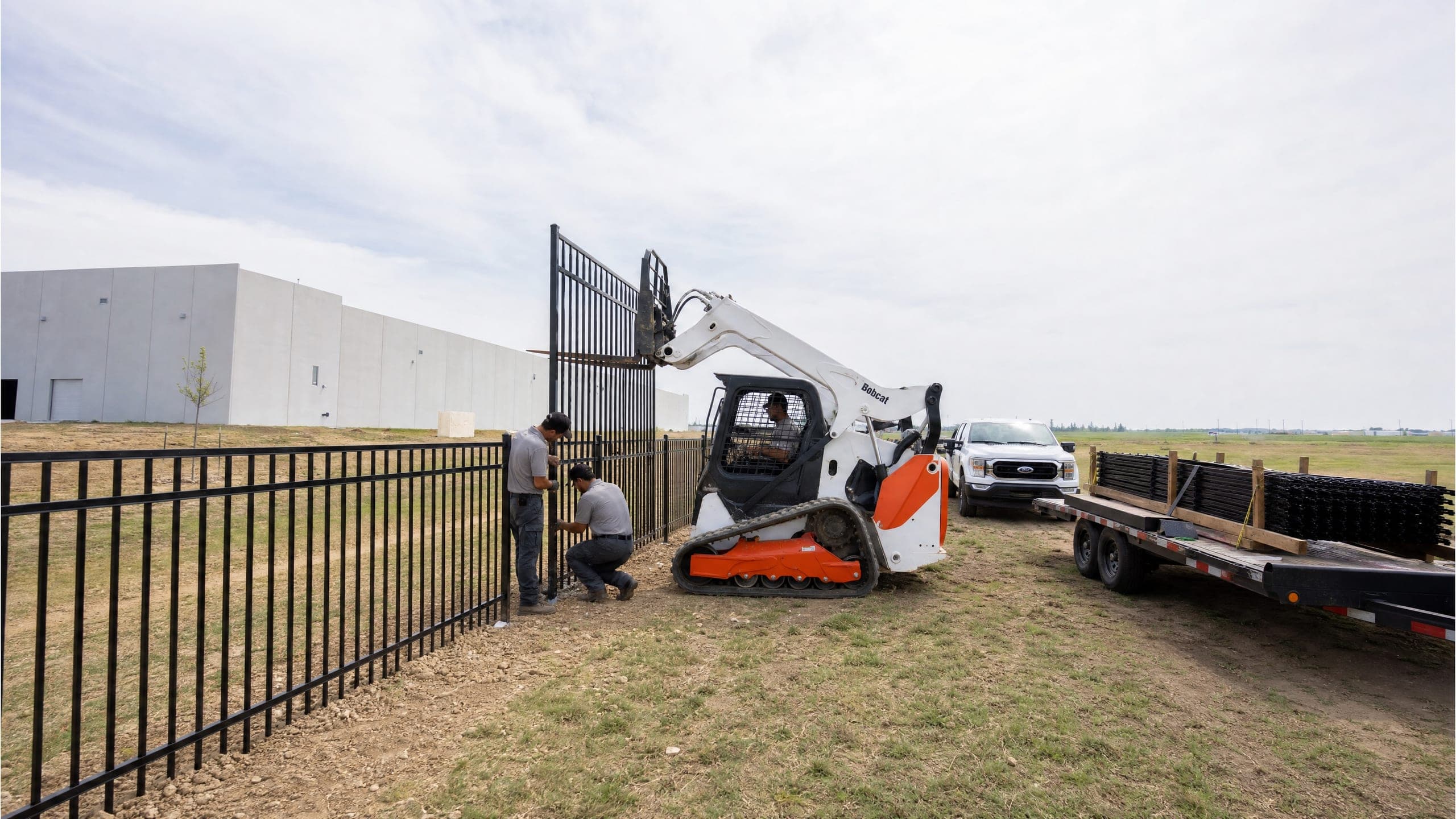 Ornamental steel panels going up along a Texas industrial campus