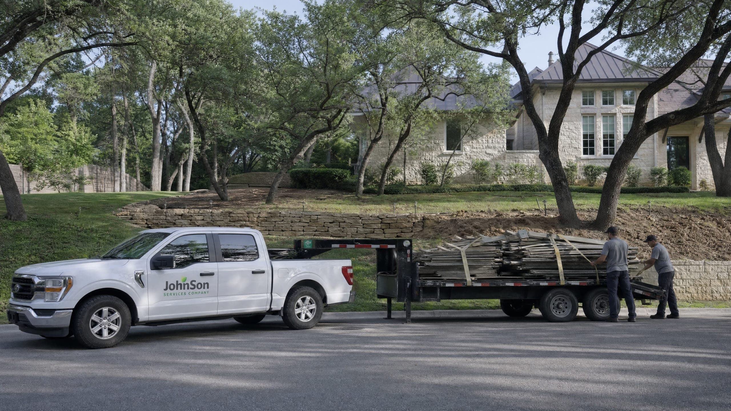 The old fence strapped down on a flatbed at the curb, ready to leave