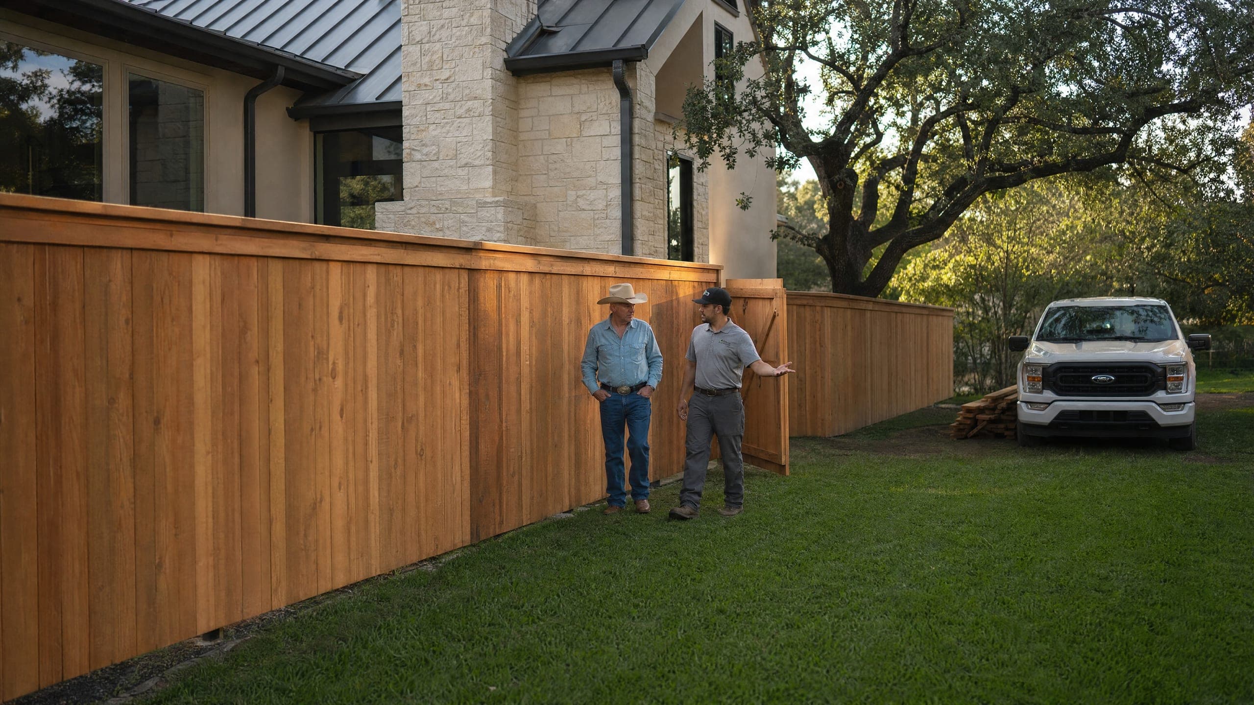The foreman and the homeowner walking the finished fence before the crew leaves