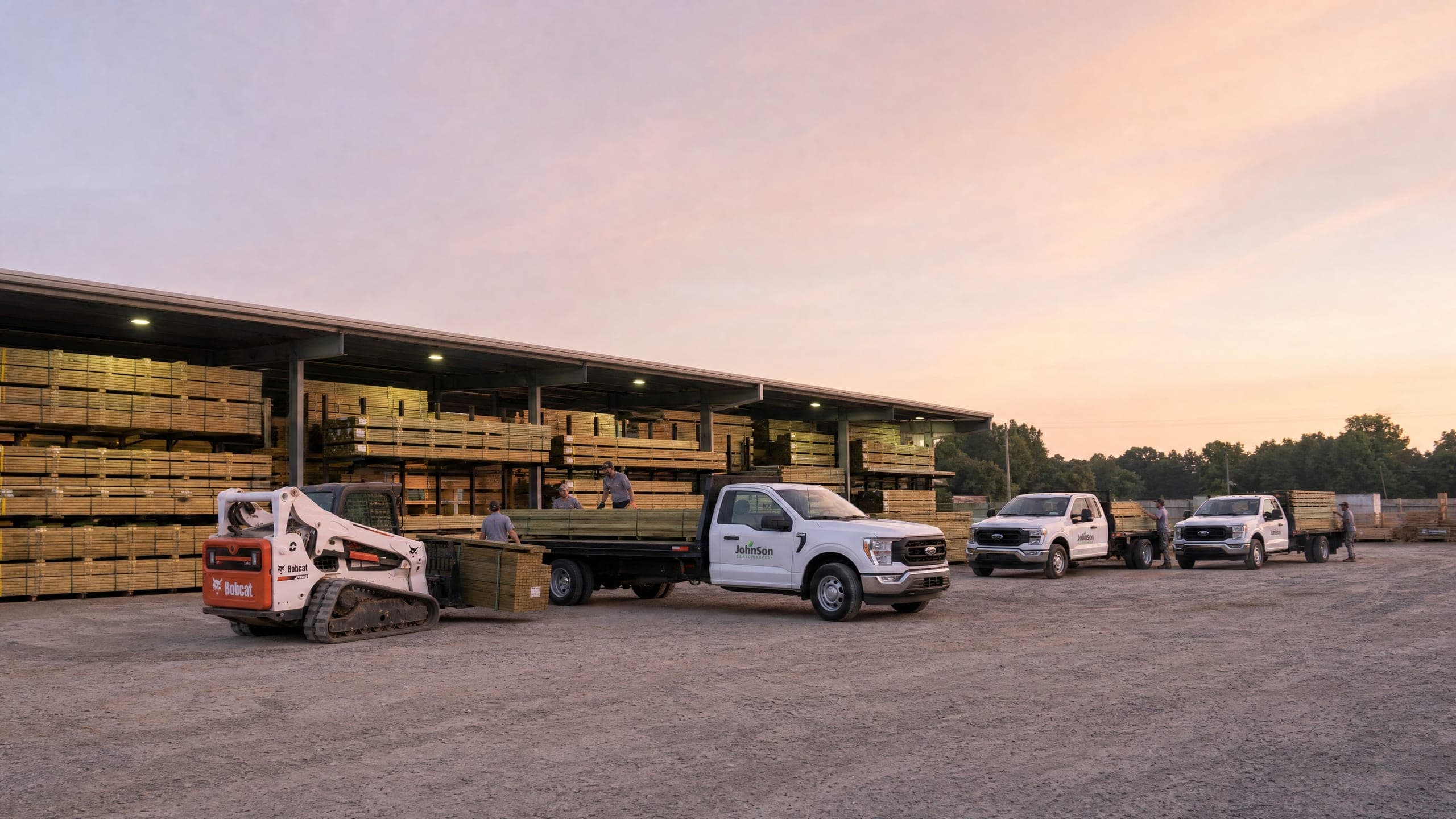 The Johnson yard at dawn, a forklift carrying banded pickets to the trucks