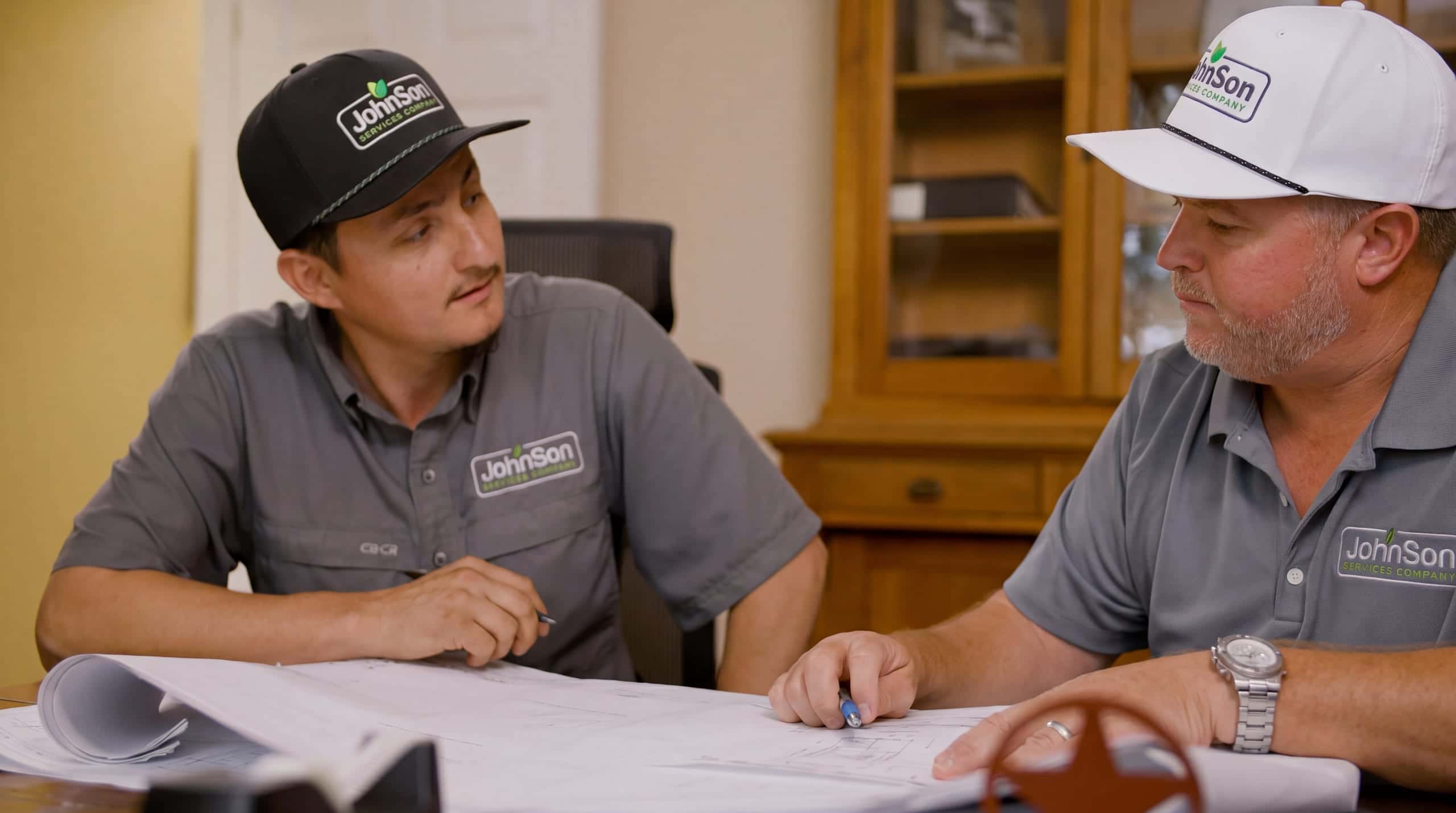 The crew lead and the salesperson reviewing the plan for a fence before the truck loads