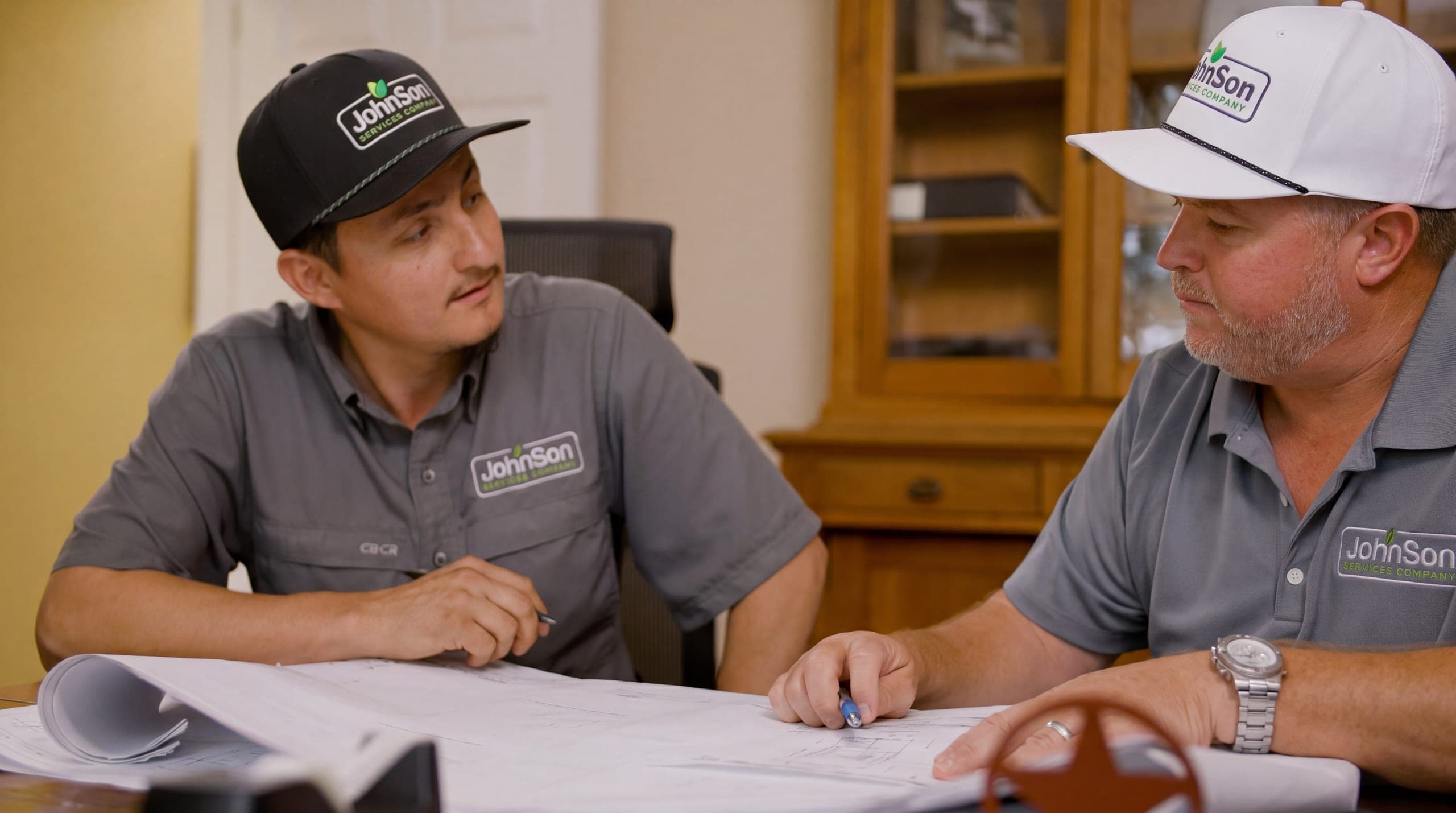 The crew lead and the salesperson reviewing the plan for a fence before the truck loads