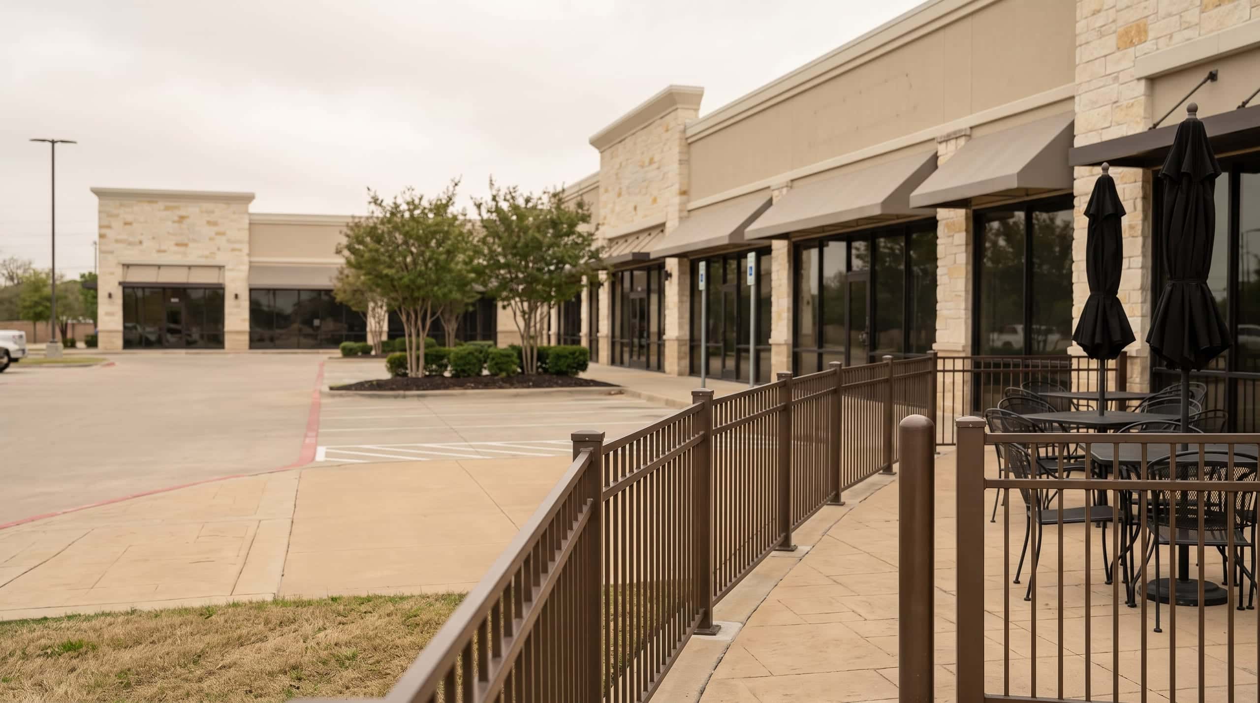 Commercial fencing on a Texas retail site, built by Johnson Fence.