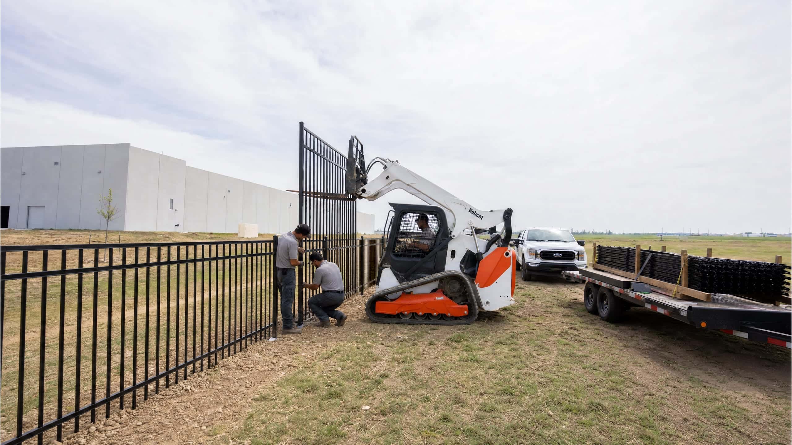 Ornamental steel panels going up along a Texas industrial campus