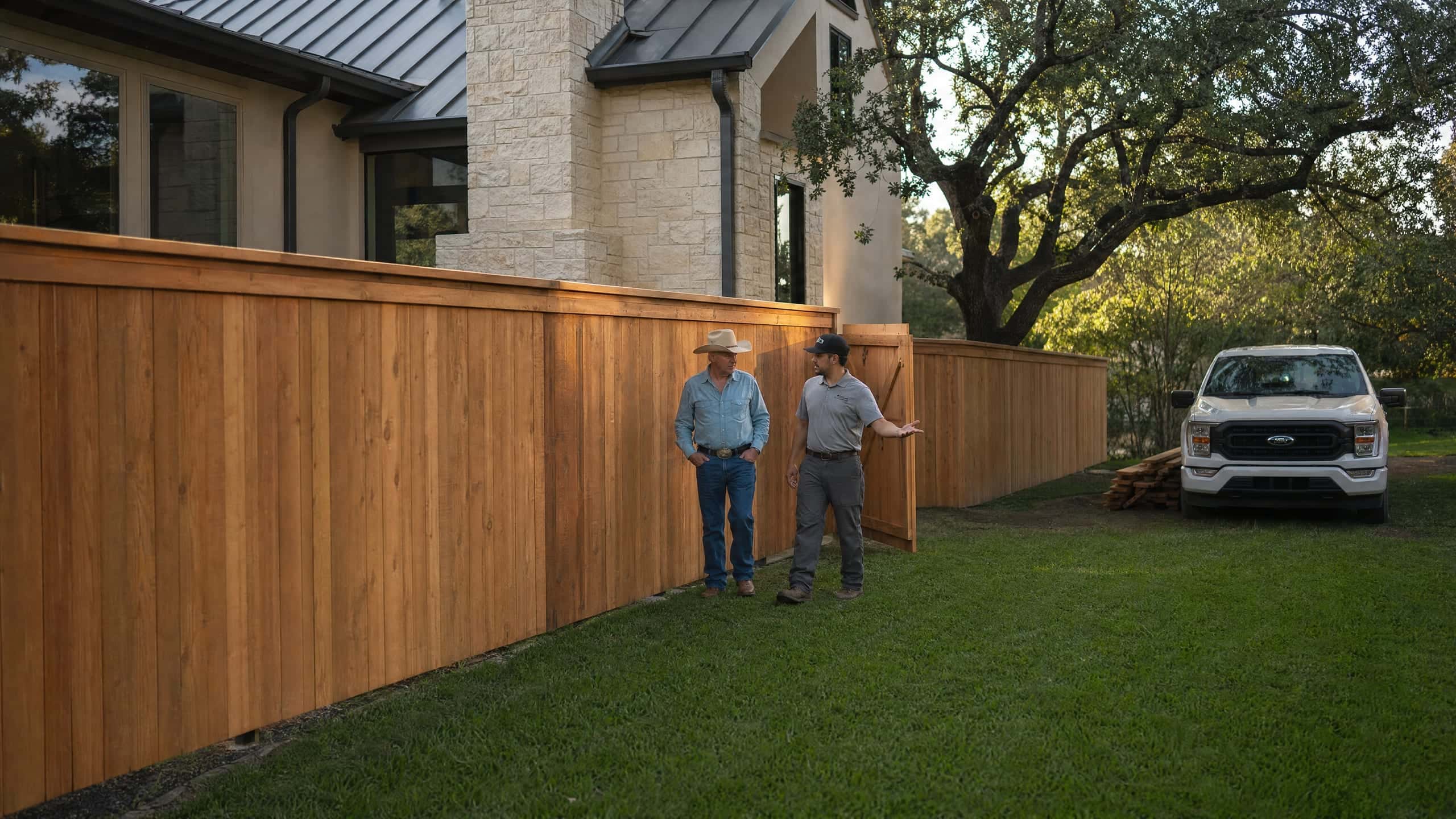 The foreman and the homeowner walking the finished fence before the crew leaves